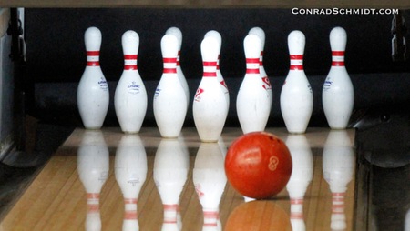 Bowling ball approaching the pins.