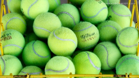 Tennis balls in a basket.